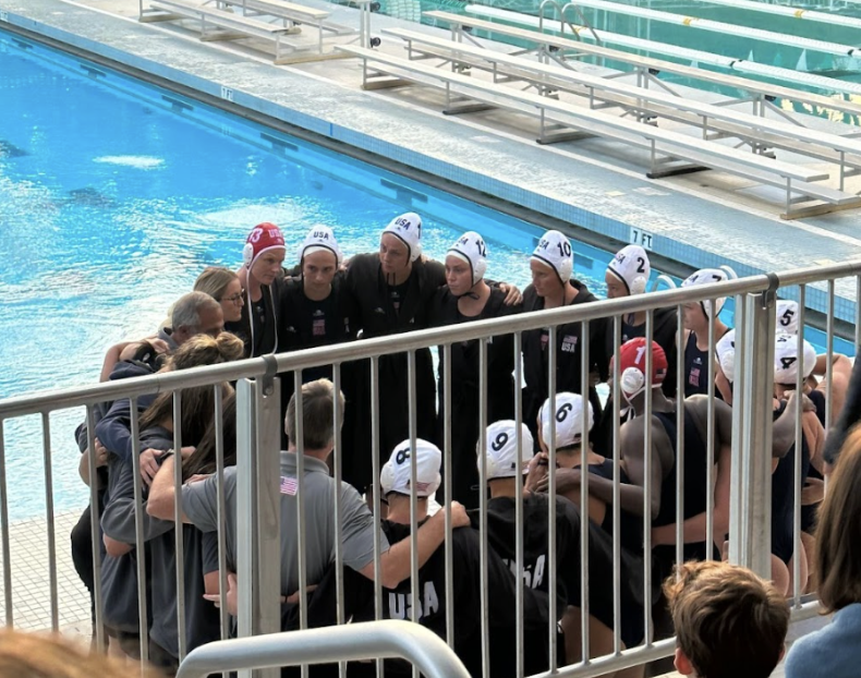 The United States womens national water polo team huddles up together, discussing their strategies and goals.
